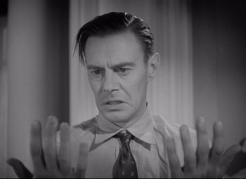 Movie still from “Mad Love” (1935), directed by Karl Freund – An old photo of a man with his hands in the air; Close Up shot, Low angle