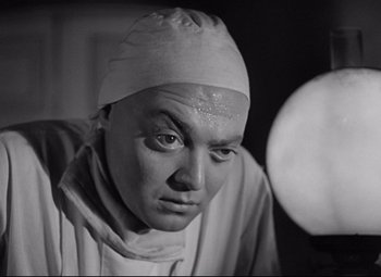 Movie still from “Mad Love” (1935), directed by Karl Freund – A black - and - white photo of a man wearing a surgical cap; Close Up shot, Low angle