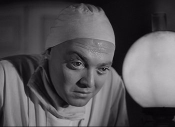 Movie still from “Mad Love” (1935), directed by Karl Freund – Black and white photograph of a man wearing a surgical cap; Close Up shot, Low angle