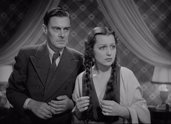 Movie still from “Mad Love” (1935), directed by Karl Freund – A man and a woman standing next to each other; Medium shot, High angle