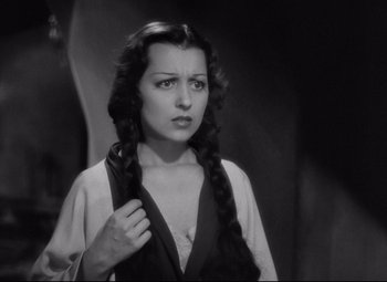 Movie still from “Mad Love” (1935), directed by Karl Freund – A black and white photo of a woman with braids; Close Up shot, High angle