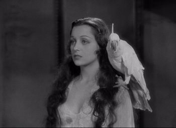 Movie still from “Mad Love” (1935), directed by Karl Freund – A woman with a bird on her shoulder; Close Up shot, Low angle