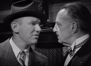 Movie still from “Mad Love” (1935), directed by Karl Freund – A black and white photo of two men facing each other; Close Up shot, Low angle