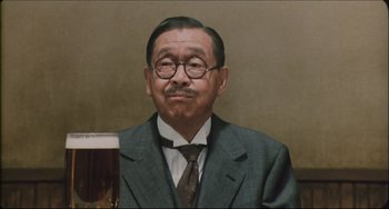 Movie still from “Madadayo” (1993), directed by Akira Kurosawa – An older man wearing a suit and tie; Close Up shot, Low angle