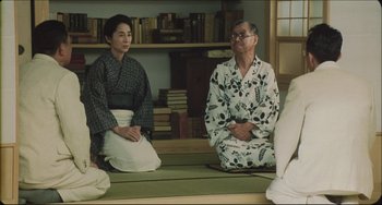 Movie still from “Madadayo” (1993), directed by Akira Kurosawa – A man and a woman sitting on the ground; Medium shot, Over the shoulder angle