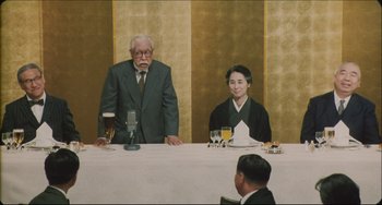 Movie still from “Madadayo” (1993), directed by Akira Kurosawa – A man and a woman sitting in front of a microphone; Medium shot, High angle