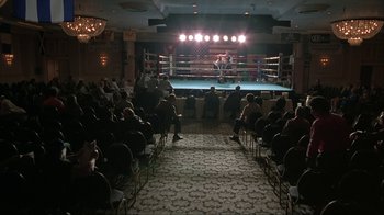 Movie still from “Made” (2001), directed by Jon Favreau – A boxing match is being held in a boxing ring; Extreme Wide shot, High angle