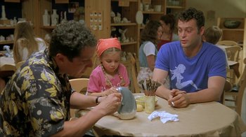 Movie still from “Made” (2001), directed by Jon Favreau – A group of people sitting around a table; Medium shot, Over the shoulder angle