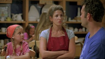 Movie still from “Made” (2001), directed by Jon Favreau – A woman in an apron is sitting in front of two other people; Close Up shot, Over the shoulder angle