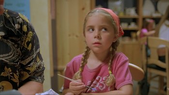 Movie still from “Made” (2001), directed by Jon Favreau – A little girl sitting at a table with a paintbrush in her hand; Close Up shot, Over the shoulder angle
