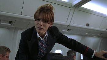 Movie still from “Made” (2001), directed by Jon Favreau – A man in a suit and tie on a plane; Close Up shot, Low angle