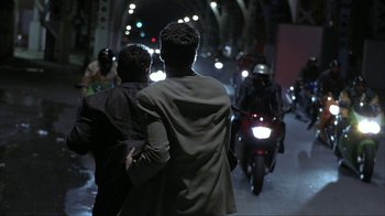 Movie still from “Made” (2001), directed by Jon Favreau – Two men standing next to each other on a street; Wide shot, Over the shoulder angle