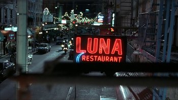 Movie still from “Made” (2001), directed by Jon Favreau – A restaurant sign lit up at night on the side of the road; Extreme Wide shot, Low angle