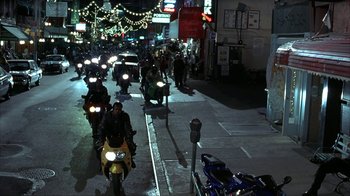 Movie still from “Made” (2001), directed by Jon Favreau – A group of people riding motorcycles down a street at night; Extreme Wide shot, High angle