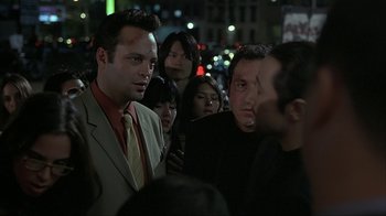 Movie still from “Made” (2001), directed by Jon Favreau – A group of people standing on a street at night; Close Up shot, Over the shoulder angle