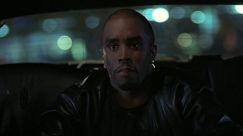 Movie still from “Made” (2001), directed by Jon Favreau – A person wearing a leather jacket; Close Up shot, Over the shoulder angle