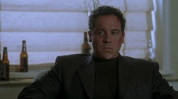 Movie still from “Made” (2001), directed by Jon Favreau – A person wearing a suit and tie; Close Up shot, Low angle