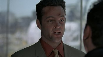 Movie still from “Made” (2001), directed by Jon Favreau – A person wearing a suit and tie; Close Up shot, Over the shoulder angle
