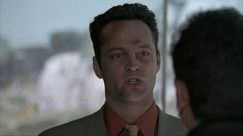 Movie still from “Made” (2001), directed by Jon Favreau – A person wearing a suit and tie; Close Up shot, Over the shoulder angle