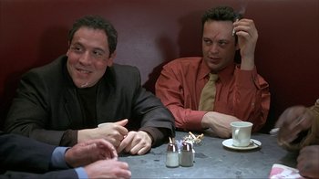 Movie still from “Made” (2001), directed by Jon Favreau – A group of men sitting at a table with drinks; Medium shot, Over the shoulder angle