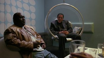 Movie still from “Made” (2001), directed by Jon Favreau – Two men sitting on a couch in a living room; Medium shot, Low angle