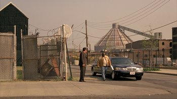 Movie still from “Made” (2001), directed by Jon Favreau – Two men standing on the side of the road; Extreme Wide shot, Low angle