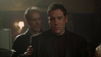 Movie still from “Made” (2001), directed by Jon Favreau – A man in a black jacket and a man in a black suit; Close Up shot, Low angle