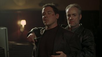 Movie still from “Made” (2001), directed by Jon Favreau – A man is shaving another man's beard; Medium shot, Low angle