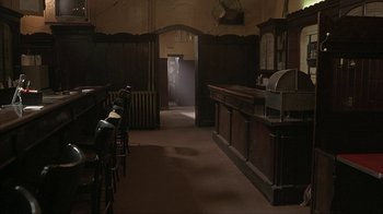 Movie still from “Made” (2001), directed by Jon Favreau – An empty bar with a clock on the wall in the background; Wide shot, High angle