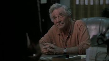 Movie still from “Made” (2001), directed by Jon Favreau – An older man sitting at a table in front of papers; Close Up shot, Over the shoulder angle