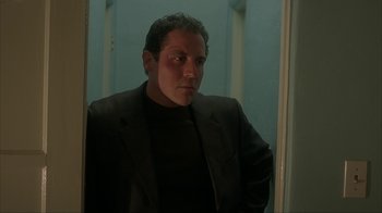 Movie still from “Made” (2001), directed by Jon Favreau – A man in a black jacket is standing in front of a mirror; Close Up shot, Low angle