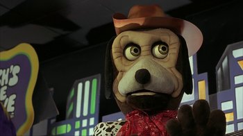 Movie still from “Made” (2001), directed by Jon Favreau – A stuffed dog wearing a cowboy hat and bandana; Close Up shot, Over the shoulder angle