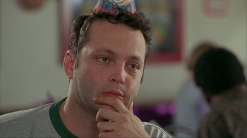 Movie still from “Made” (2001), directed by Jon Favreau – A person wearing a party hat; Close Up shot, High angle