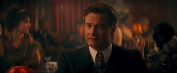 Movie still from “Magic in the Moonlight” (2014), directed by Woody Allen – A person wearing a suit and tie; Close Up shot, Over the shoulder angle