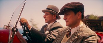 Movie still from “Magic in the Moonlight” (2014), directed by Woody Allen – A couple of men in suits and hats driving a car; Close Up shot, Low angle