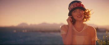 Movie still from “Magic in the Moonlight” (2014), directed by Woody Allen – A beautiful young lady wearing a floral hat; Medium shot, Over the shoulder angle