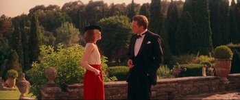 Movie still from “Magic in the Moonlight” (2014), directed by Woody Allen – A man and a woman in formal wear standing next to each other; Medium shot, Over the shoulder angle