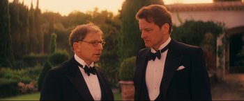 Movie still from “Magic in the Moonlight” (2014), directed by Woody Allen – Two men in tuxedos standing next to each other; Medium shot, Over the shoulder angle