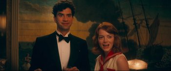 Movie still from “Magic in the Moonlight” (2014), directed by Woody Allen – A man and a woman posing for a picture; Medium shot, Over the shoulder angle