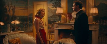 Movie still from “Magic in the Moonlight” (2014), directed by Woody Allen – A woman and a man standing in front of a fireplace; Medium shot, Over the shoulder angle