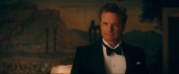 Movie still from “Magic in the Moonlight” (2014), directed by Woody Allen – A person wearing a suit and a bow tie; Medium shot, Over the shoulder angle