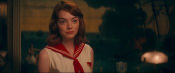 Movie still from “Magic in the Moonlight” (2014), directed by Woody Allen – A woman in a sailor's uniform is looking at the camera; Close Up shot, Over the shoulder angle