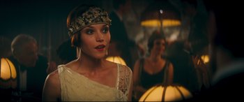 Movie still from “Magic in the Moonlight” (2014), directed by Woody Allen – A woman in a white dress and a headband; Close Up shot, Over the shoulder angle