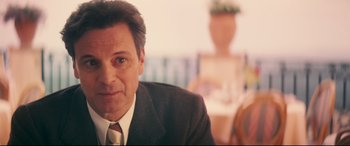 Movie still from “Magic in the Moonlight” (2014), directed by Woody Allen – A person wearing a suit and tie; Close Up shot, Over the shoulder angle
