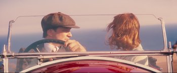 Movie still from “Magic in the Moonlight” (2014), directed by Woody Allen – A man and a woman in the back seat of a car; Medium shot, Low angle