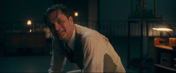 Movie still from “Magic in the Moonlight” (2014), directed by Woody Allen – A man wearing a white shirt and a red tie; Close Up shot, Low angle