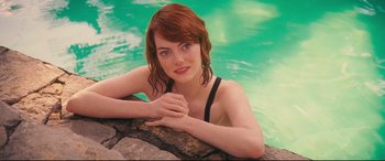 Movie still from “Magic in the Moonlight” (2014), directed by Woody Allen – A beautiful young lady sitting in a swimming pool; Close Up shot, High angle