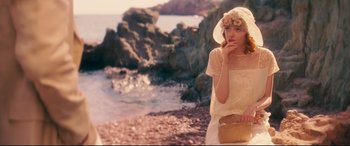 Movie still from “Magic in the Moonlight” (2014), directed by Woody Allen – A woman in a white dress and a straw hat; Medium shot, High angle