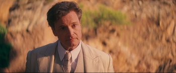 Movie still from “Magic in the Moonlight” (2014), directed by Woody Allen – A person wearing a suit and tie; Close Up shot, Over the shoulder angle