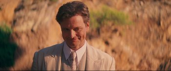 Movie still from “Magic in the Moonlight” (2014), directed by Woody Allen – A person wearing a suit and tie; Close Up shot, Over the shoulder angle